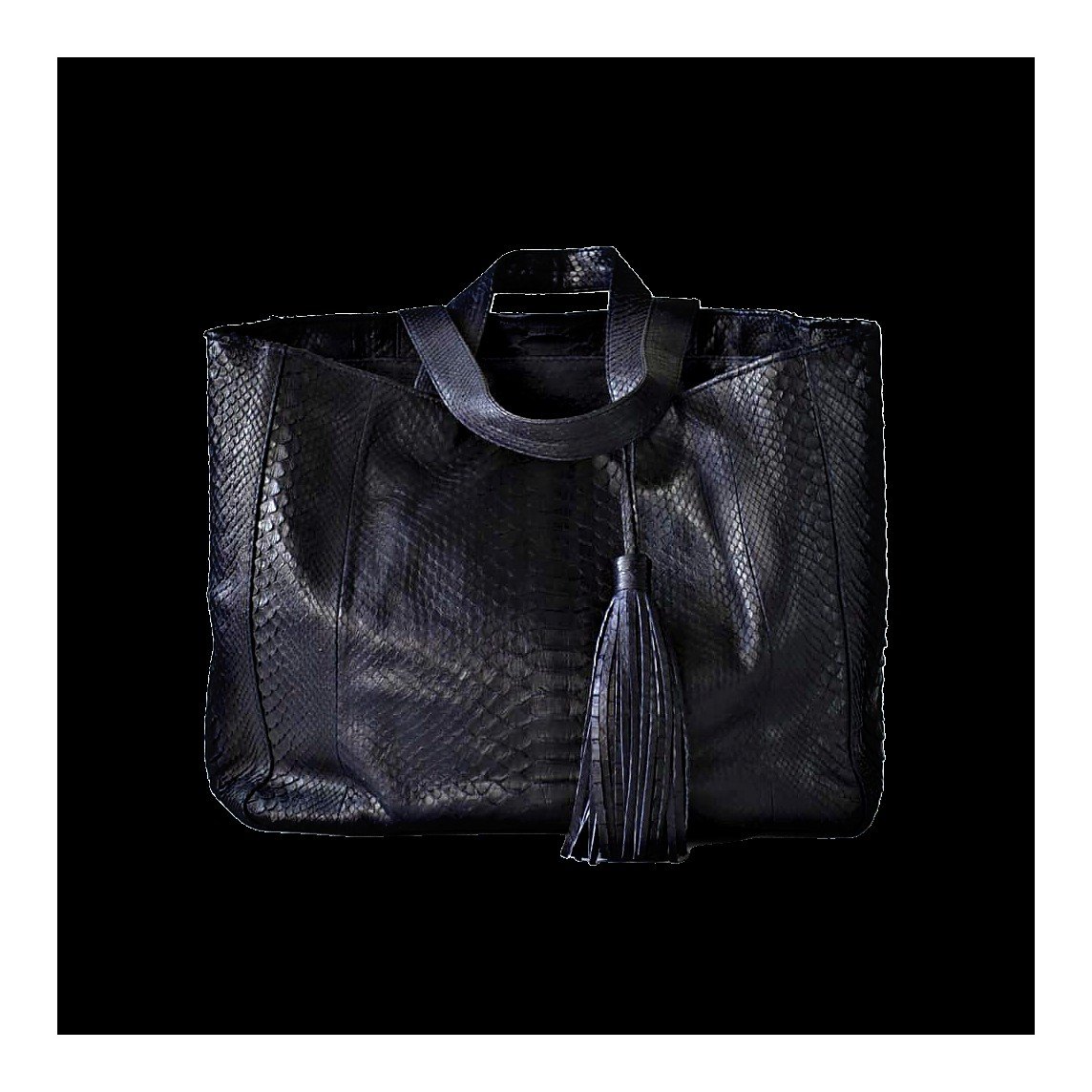 Python leather in the atelier — raw pelts and finished piece